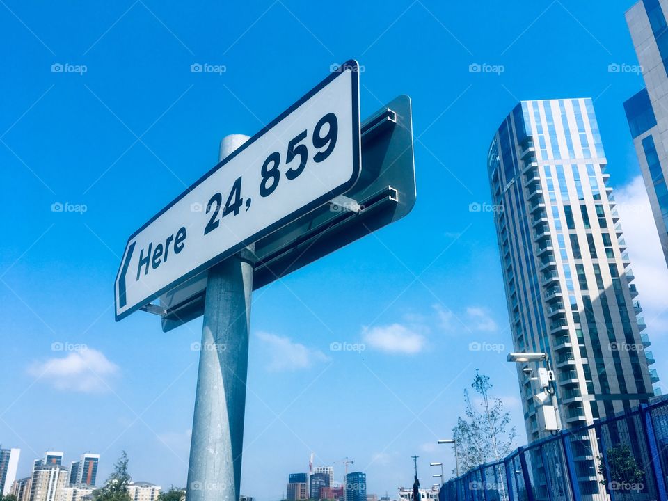 ‘Here 24,859’ miles sign by artists Thomson and Craighead, at Greenwich Peninsula 