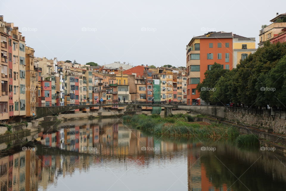 Colourful buildings reflecting in a pond -Girona, Catalonia