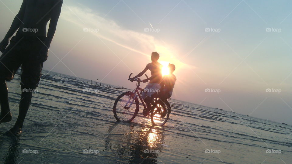 Riding bicycle . people riding bicycle in sunset Beach