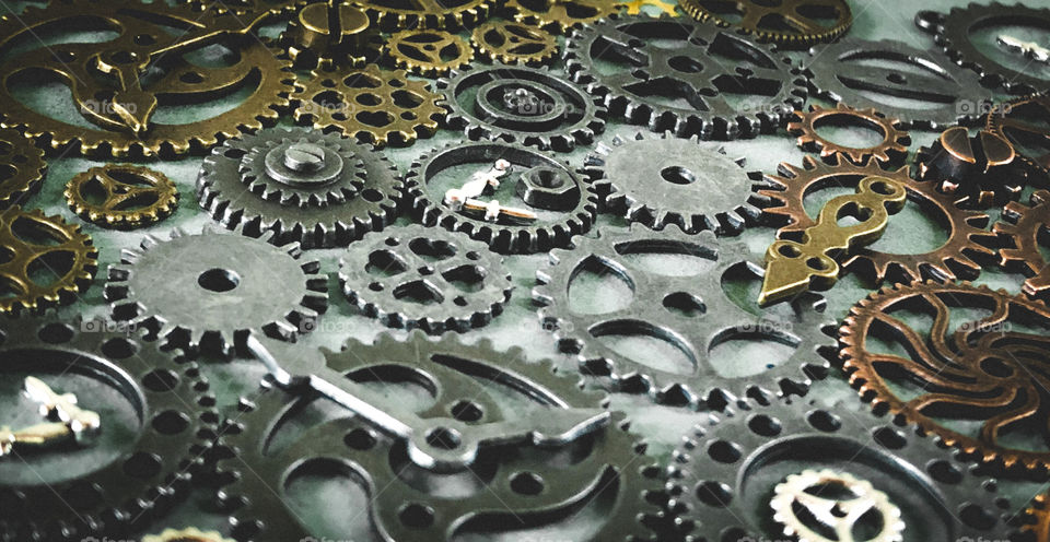 Copper, bronze and steel gears laid out, close up