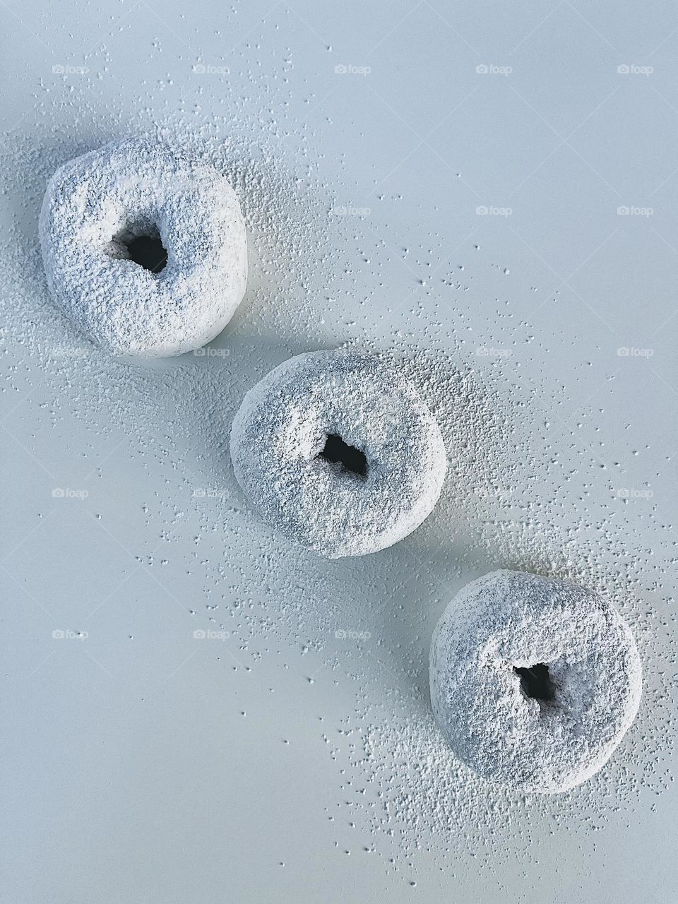 Three White Powdered Donuts