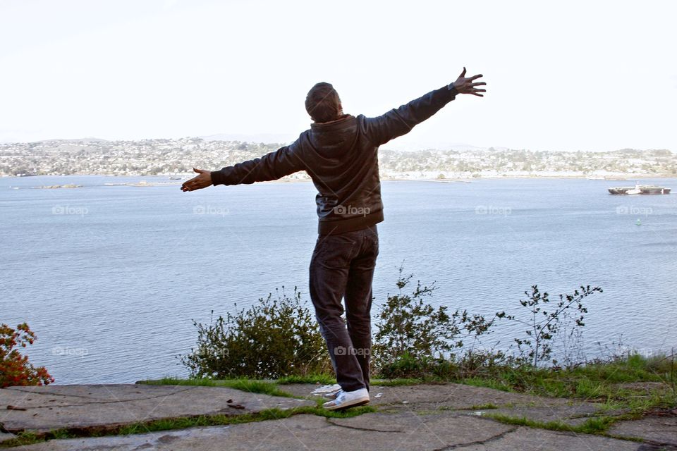 Young man next to water 