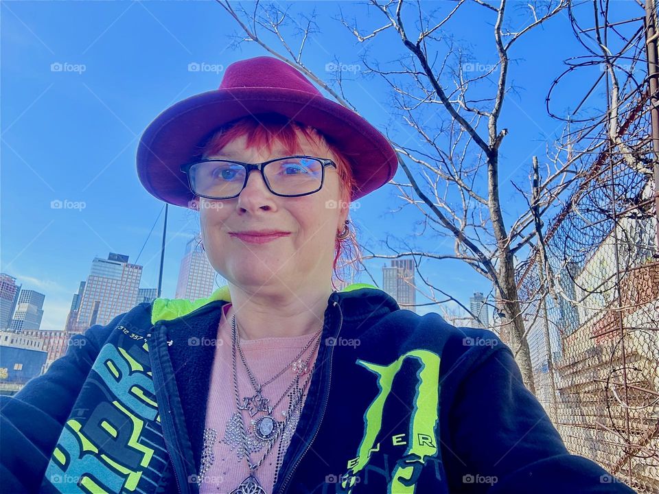 This is me, “Petra Schiller” a.k.a. “Maxine Firefox” in the parking lot beneath the “Pulaski Bridge” at “Newtown Creek” in LIC, Queens by the wall we walk along to our “28 ft 1969 Luhrs” cabin cruiser “Salvation”. 2024. Hypnotic Productions