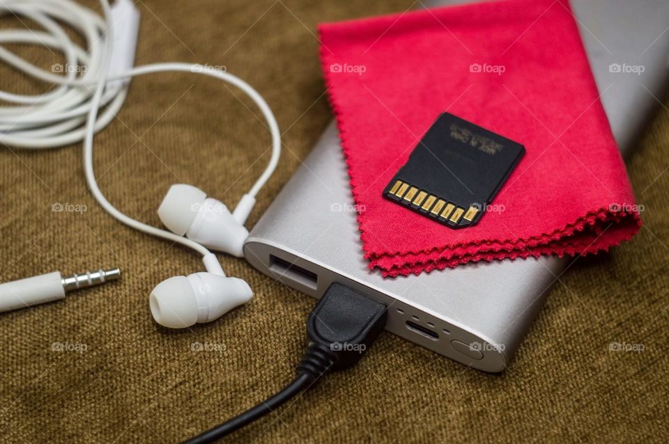 my favorite power bank is cleaning for camera lenses and a spare flash drive with headphones