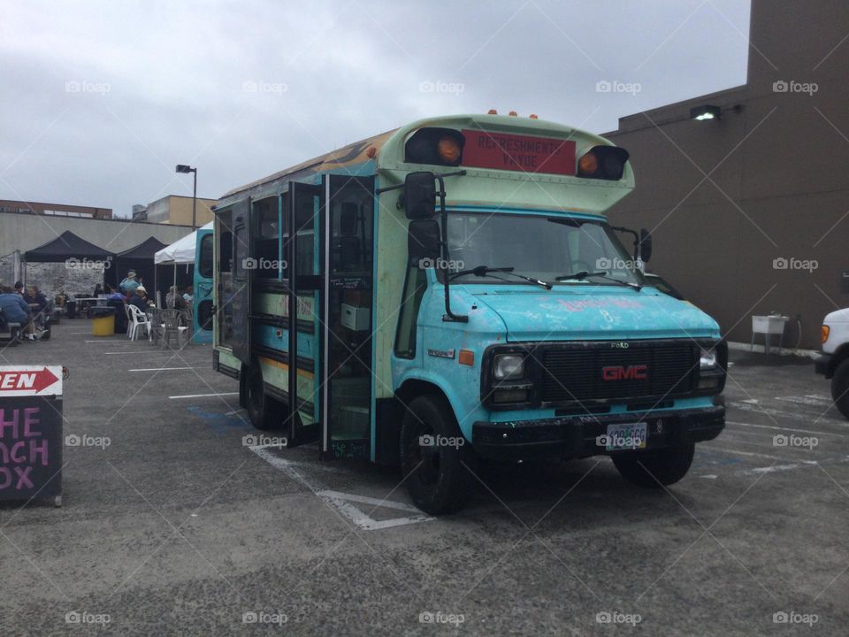 A Funky Vintage Bus Painted Blue at a Farmers' Market 