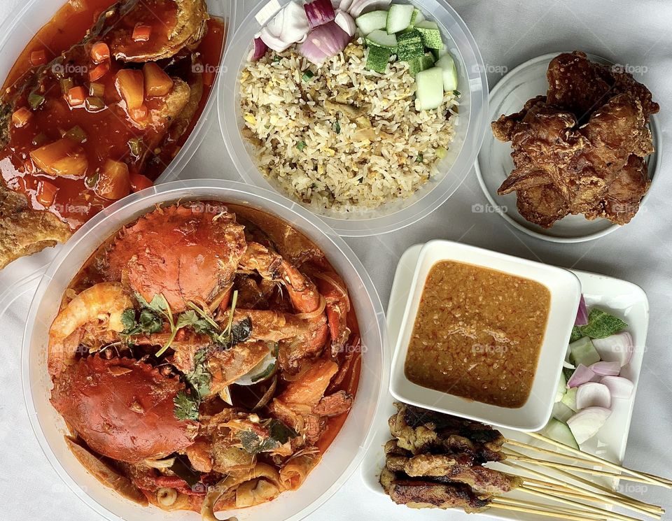 Halal feast consisting of chilli crab shellout, chicken satay fried rice, chicken satay sticks, sweet sour seabass and chicken wings 