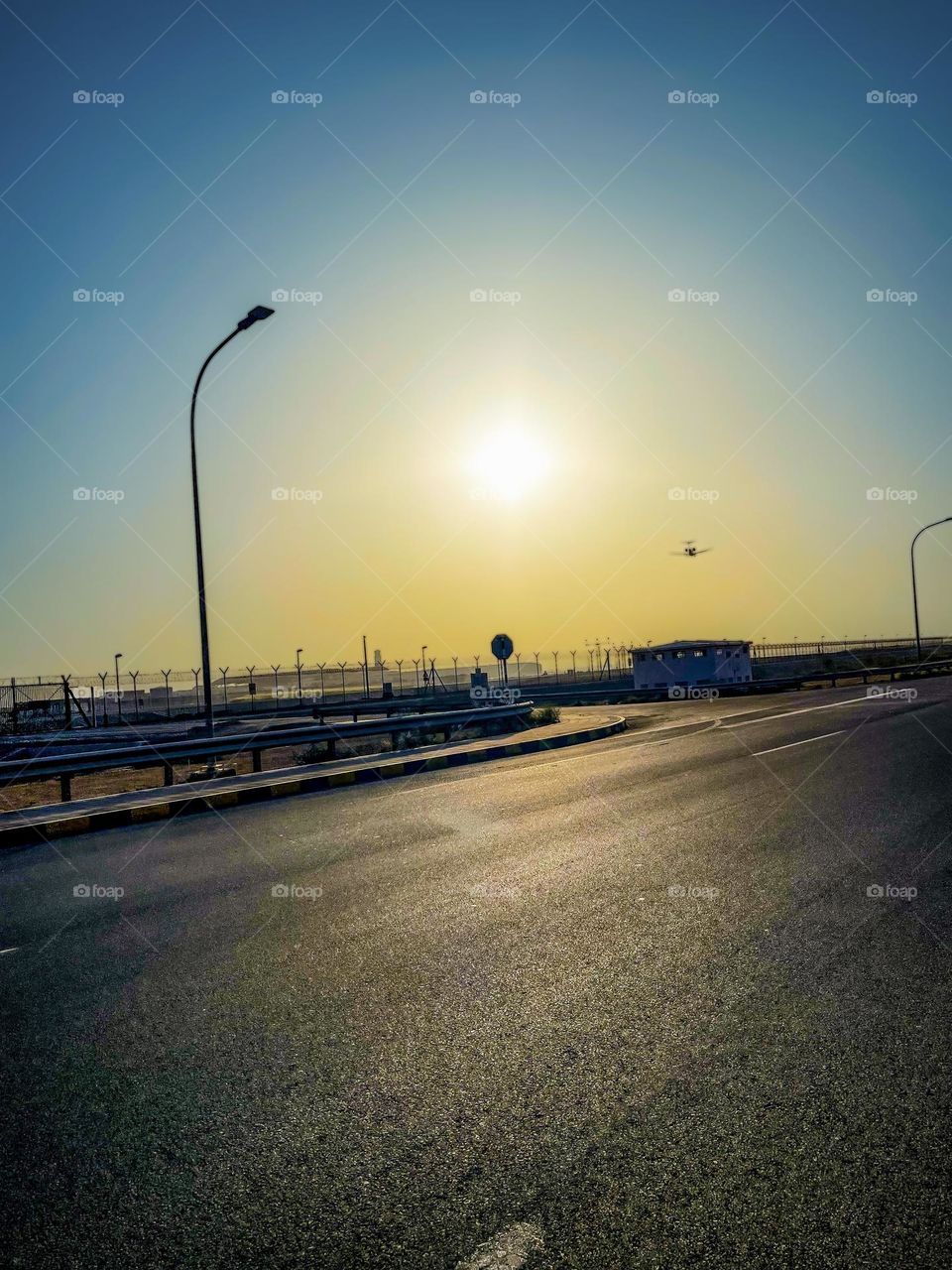 A private jet during its final approach at Muscat International Airport, at sunset.