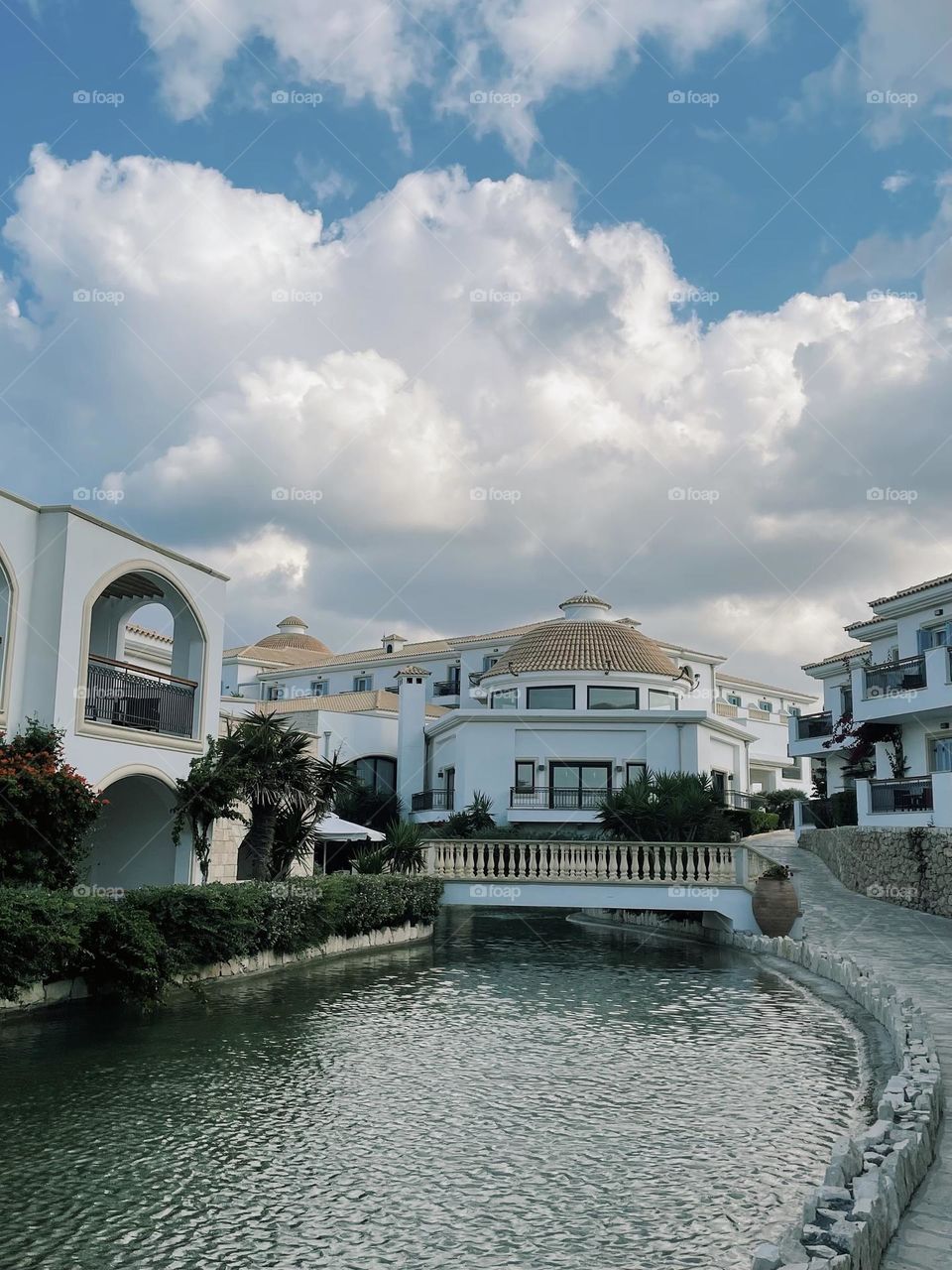 A bridge sits over a small man made lazy river running throughout the grounds of a Greek beach hotel, September 2021.
