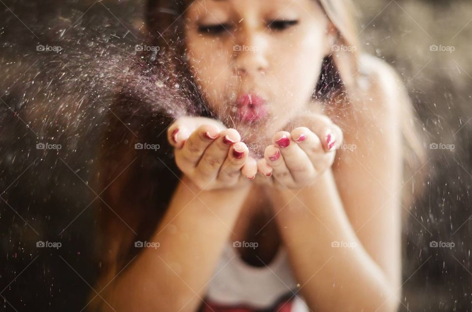Girl blowing glitter 
