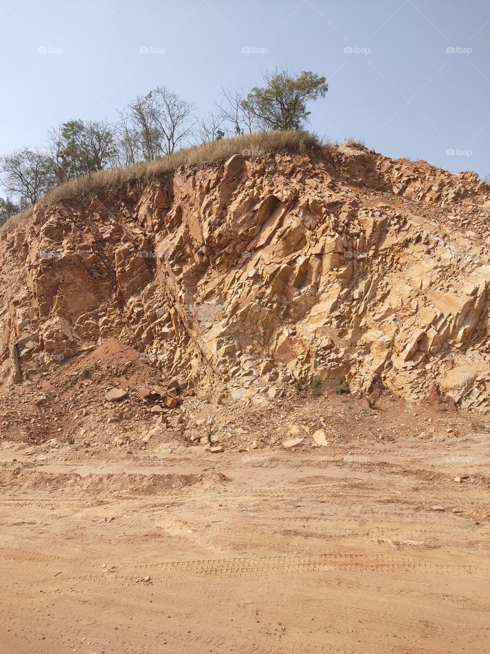 Road is being made by cutting stones.