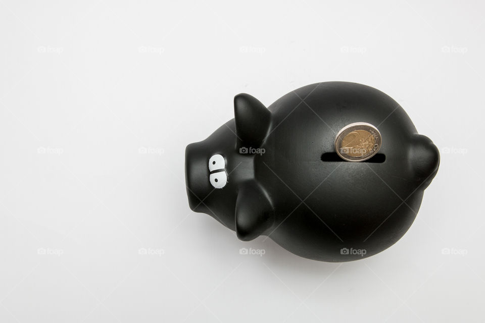 Black Piggy Bank With Coin, Isolated In White Backgound
