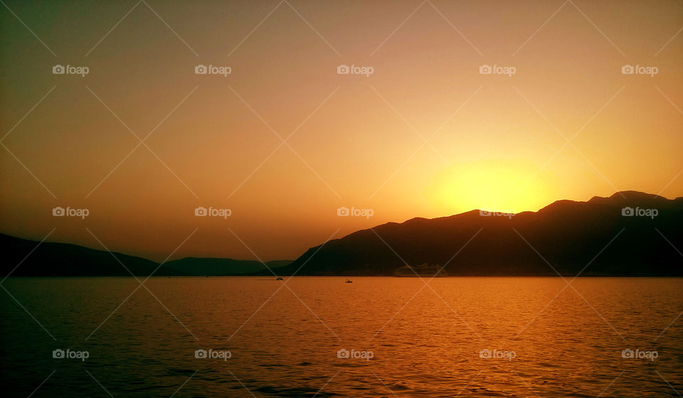 amazing orange sunset, sea and mountains