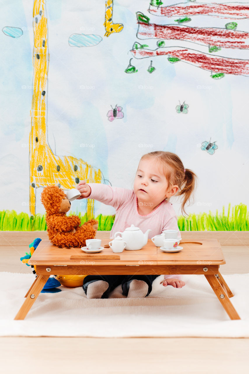 Small girl playing with soft toy