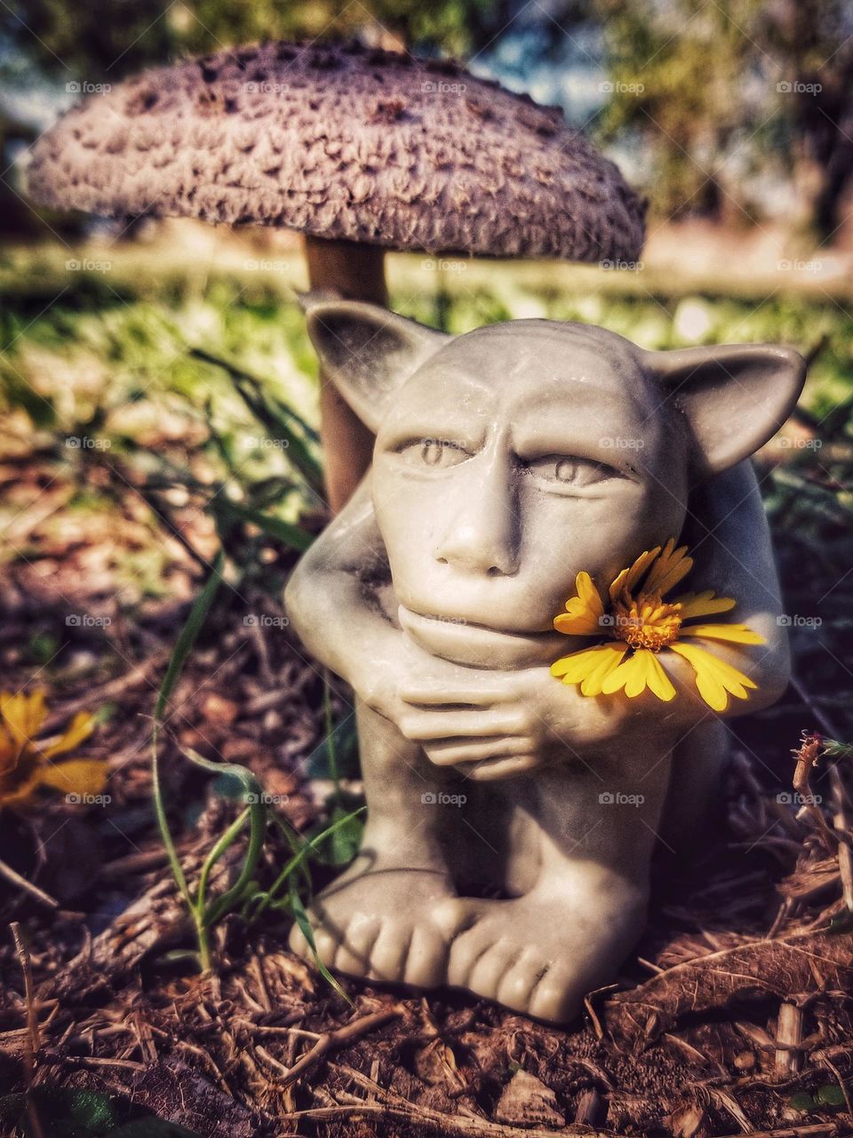 Small Gargoyle holding flowers under a Parasol Mushroom