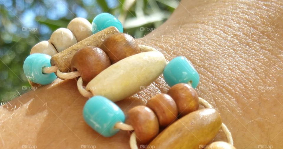 Wood beads bracelet closeup with turquoise beads