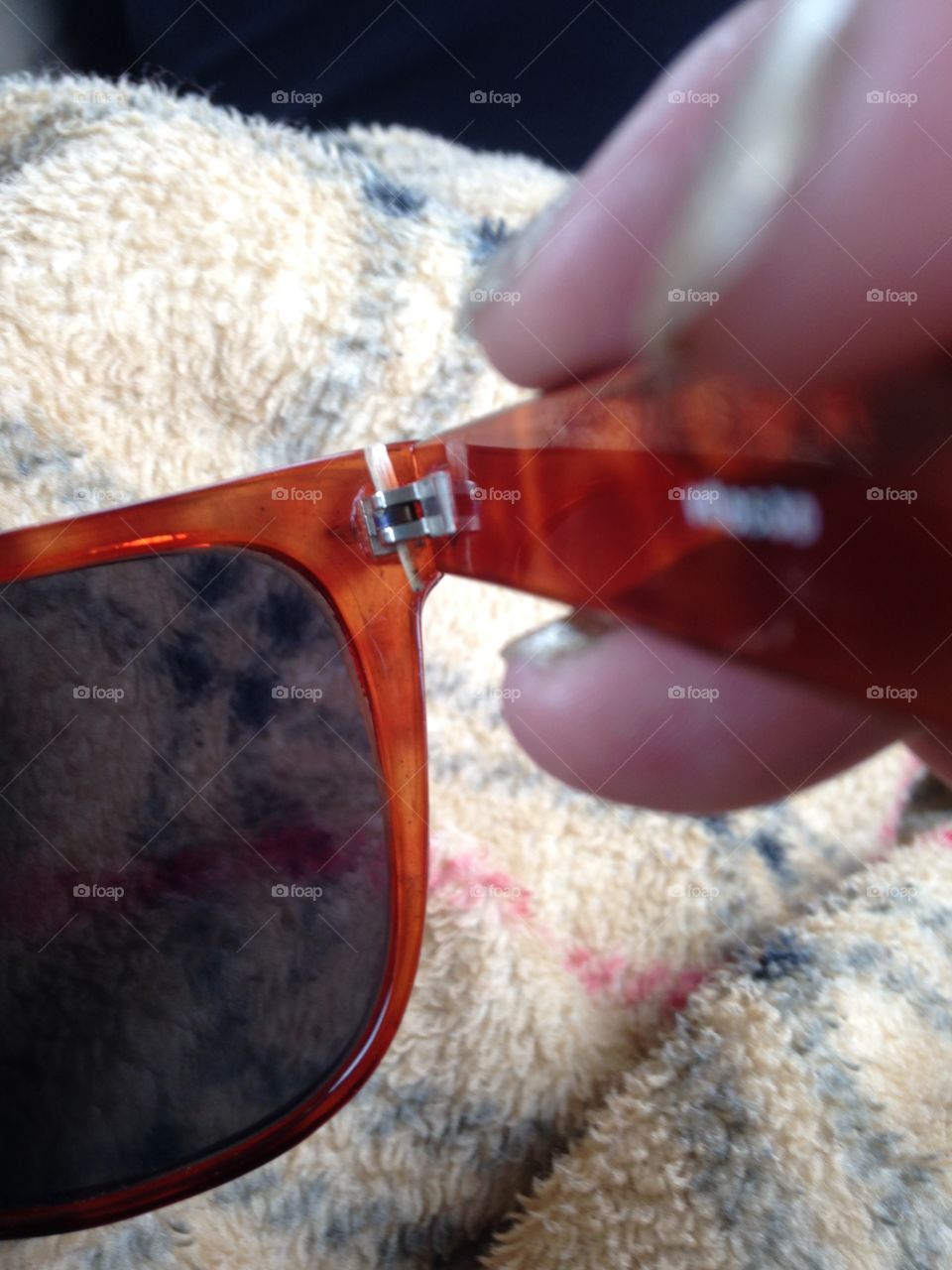 Sunglasses repaired with a toothpick. 