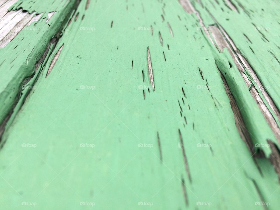 Weathered green paint on a picnic table