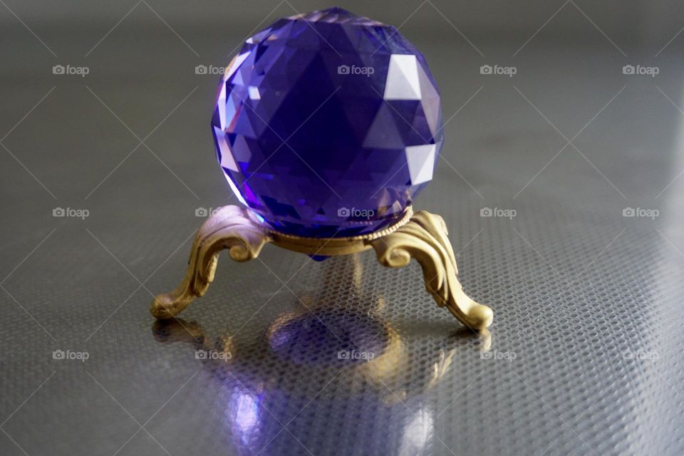 A multi faceted crystal sphere, often times used by Feng Shui Practioners in spaces to remedy chi energy.  Creates a sparkling effect from refracted light. 