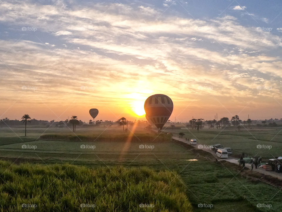 Balloon over vegetables fields on sunrise background in Egypt 