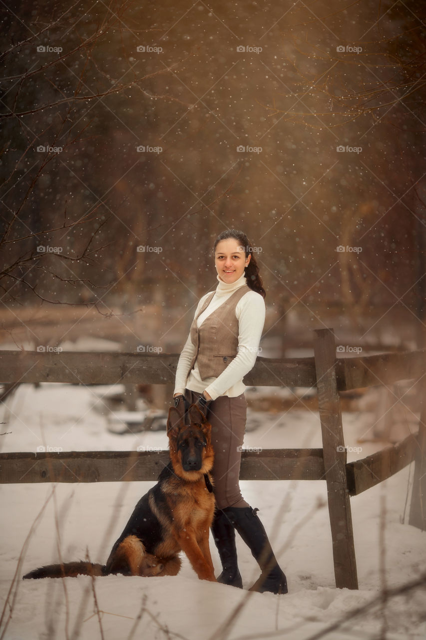 Young beautiful woman with German shepherd dog outdoor portrait at spring day