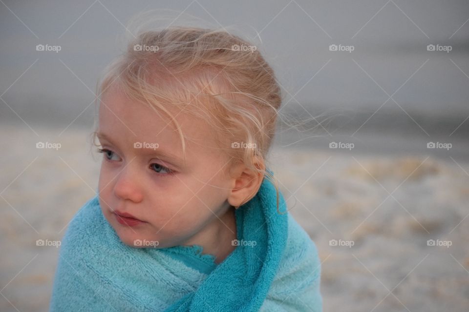 Cold little girl at the beach