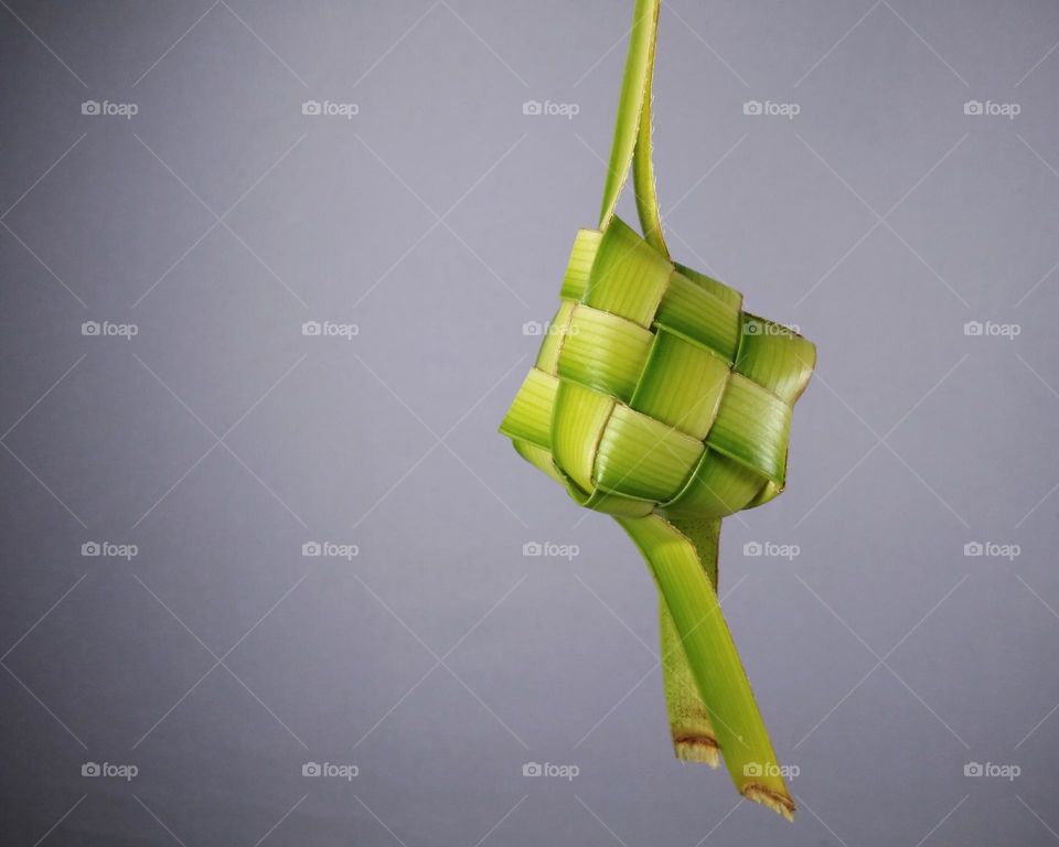 ketupat,  made from woven coconut leaf.  fill with rice before cooking.  Indonesian culture