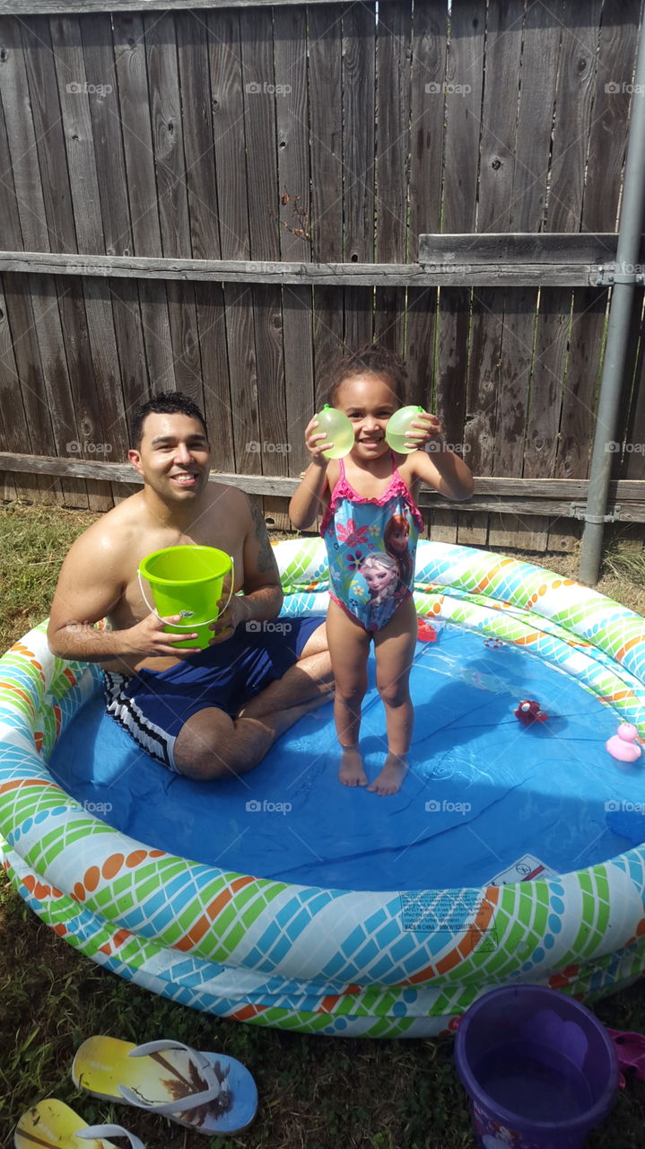 father and daughter in baby pool