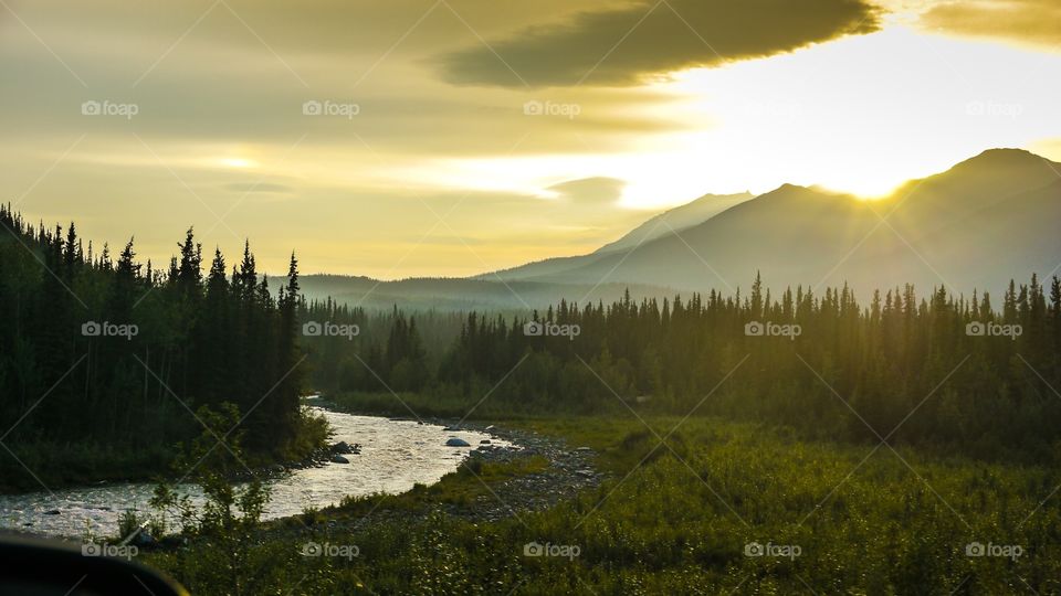 Mountain sunset. Alaska Denali national park into the wild sunset with mountain River and forest