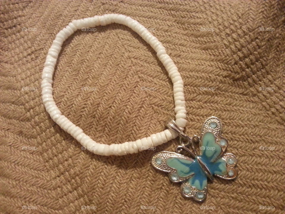 I got a blue butterfly charm to be attached to a mini shell rubber band bracelet on it.