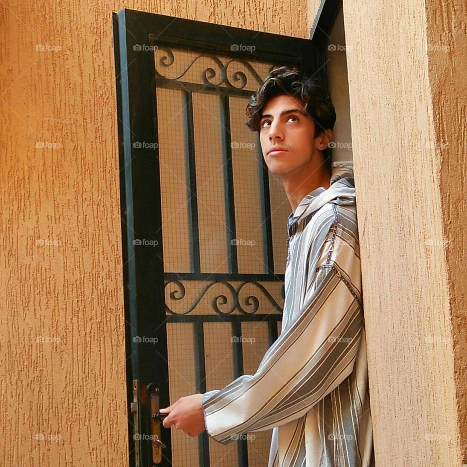 A young and handsome man wearing moroccan jellaba