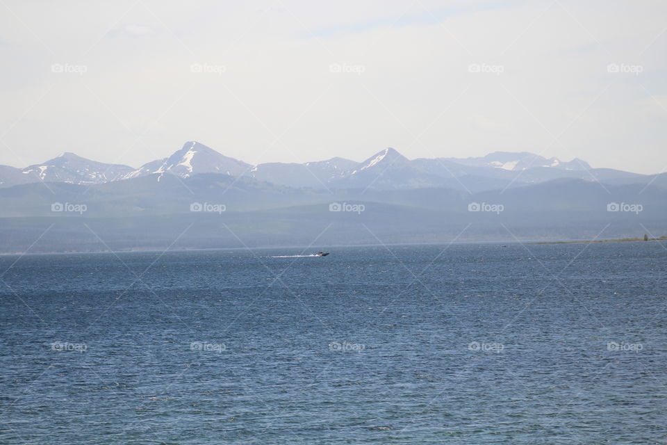 Unedited water leak ocean mountains Mountain View snowy blue boat boating sun travel Sky skies