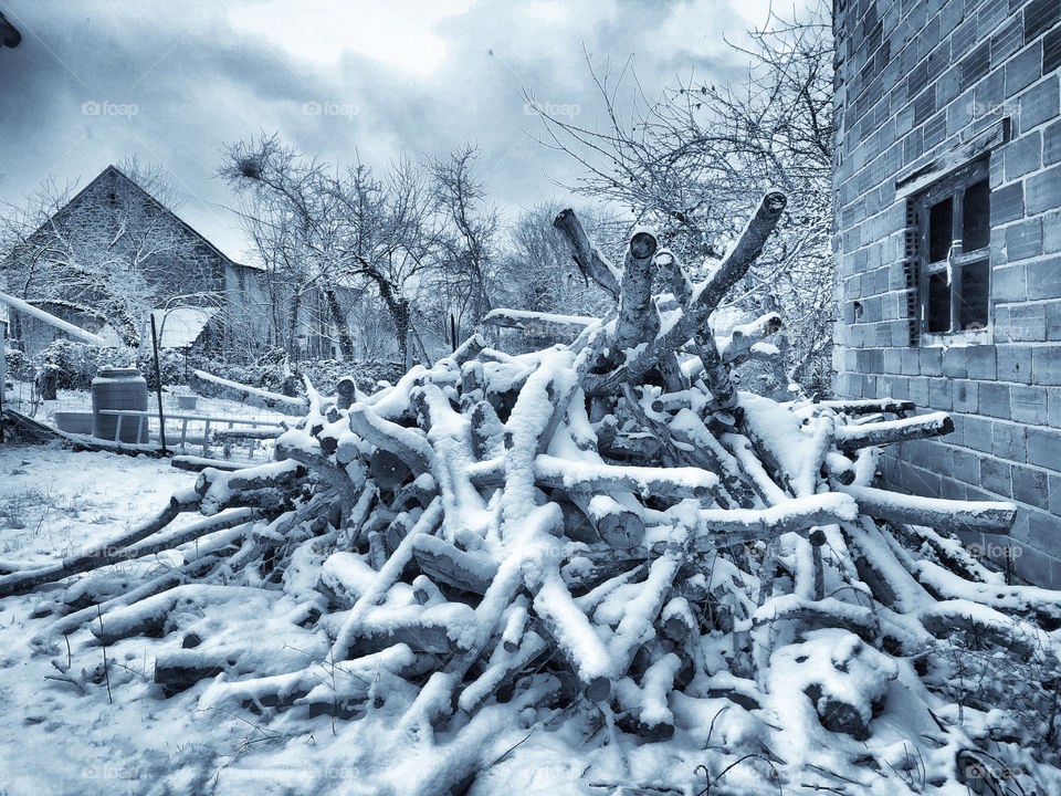 A wood pile covered in snow, rural France - January 2019