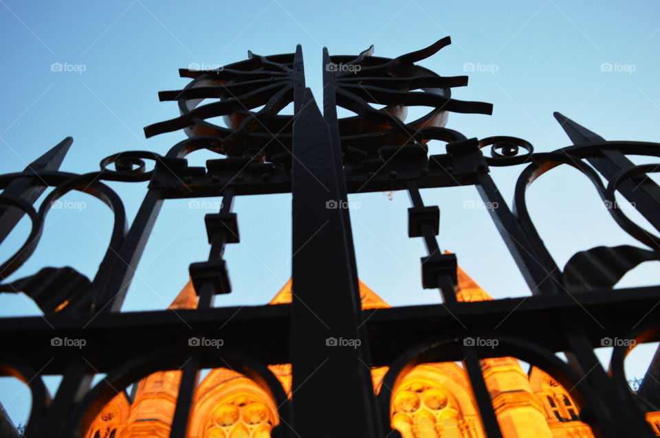 looking up. gate of the university at dusk