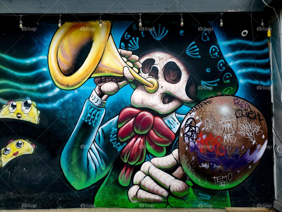 Street art celebrating Dia De Los Muertos/ Day of the Dead. A Mexican cultural tradition of remembering and celebrating those that have passed. The art depicts dead Mexican culture musicians.