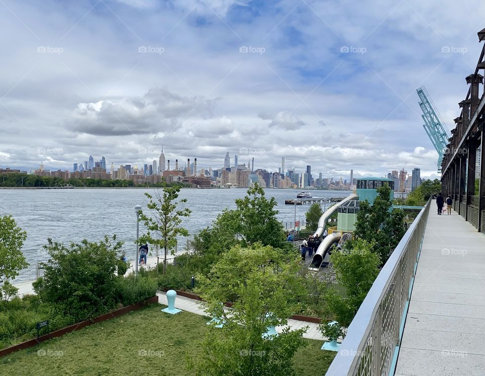 East river with Manhattan view from elevated trestle, Domino Park, Brooklyn NY