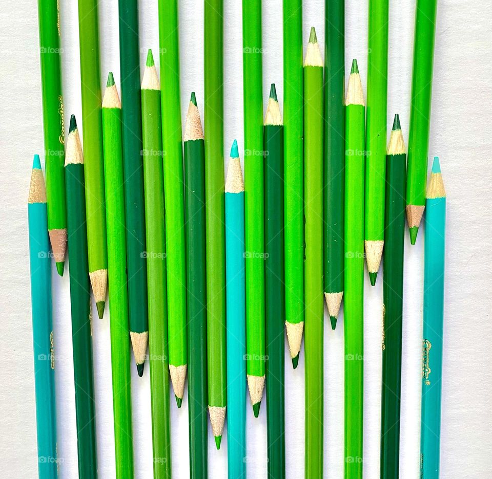 Shades of green, colored pencils shaped like a heart