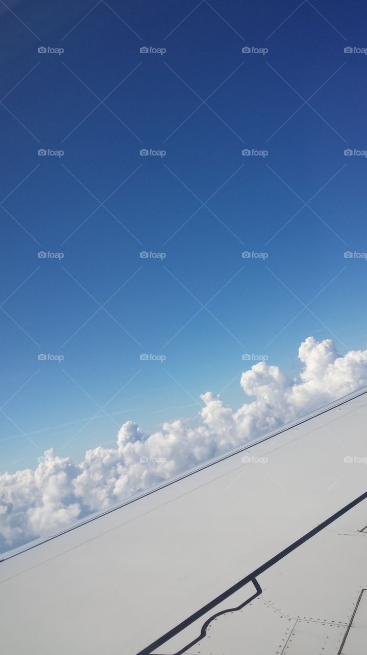 clouds beyond the wing