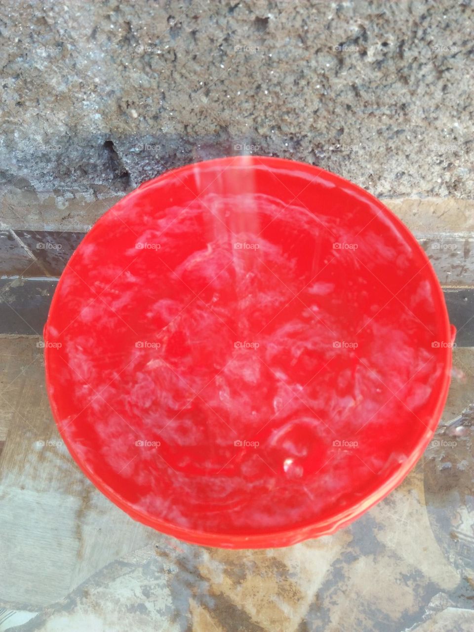 Red bucket and droplets of water.