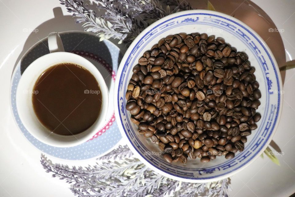 A cup of coffee and coffee beans