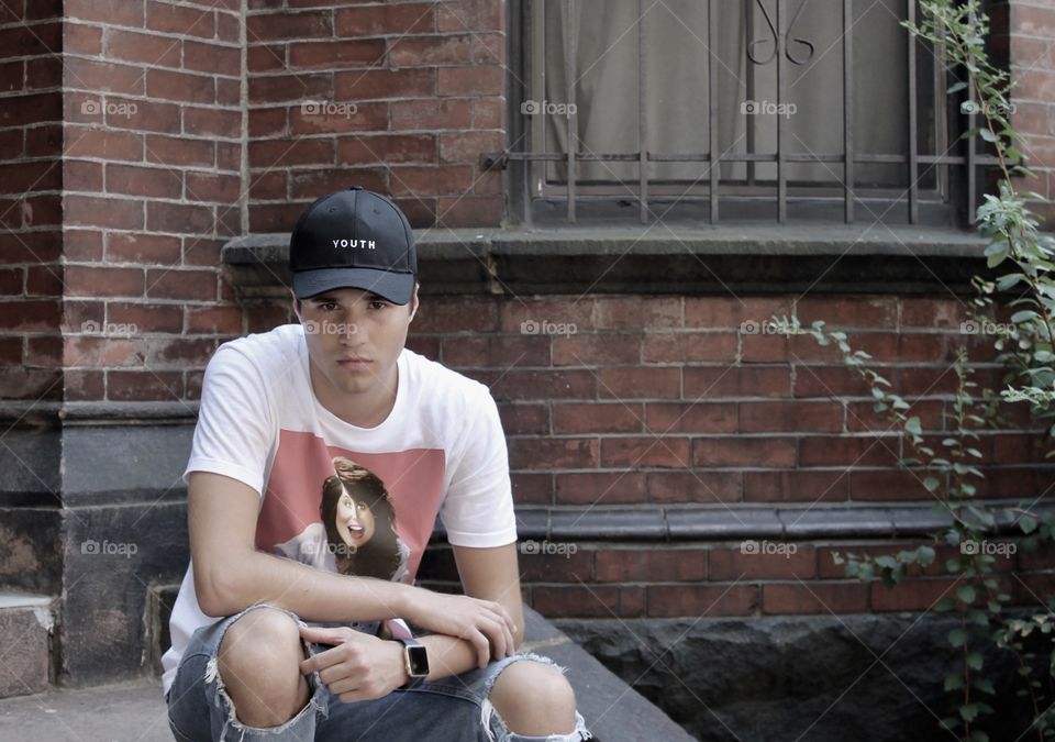 Portrait of man sitting on floor