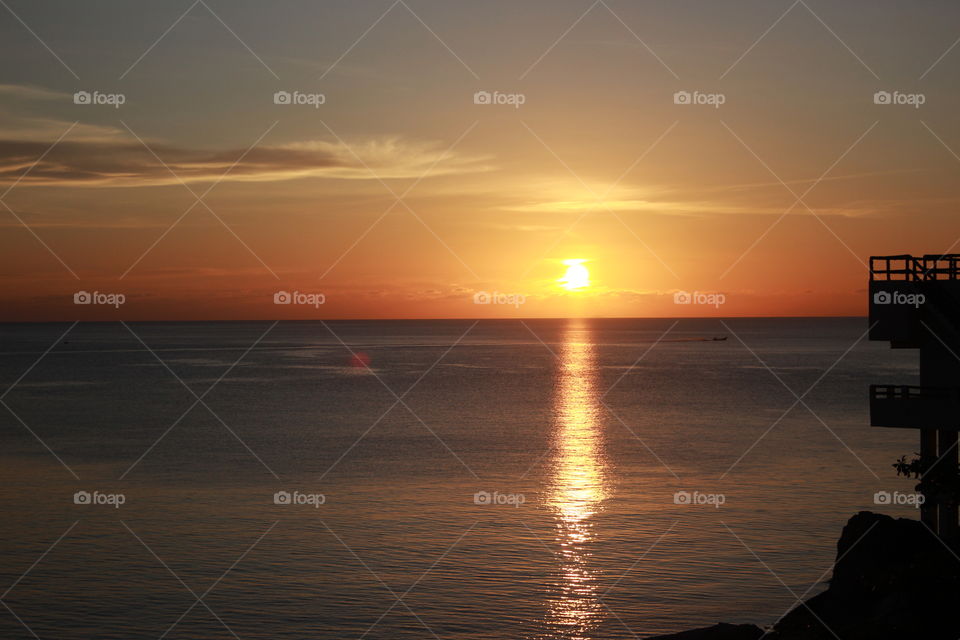 Golden hour in Koh Tao, Thailand. A beautiful colourful sunset, you can feel the peace and the local customs. Small boats.