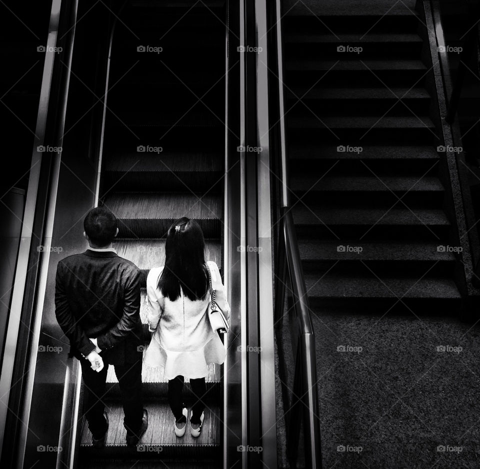 A couple on an escalator
