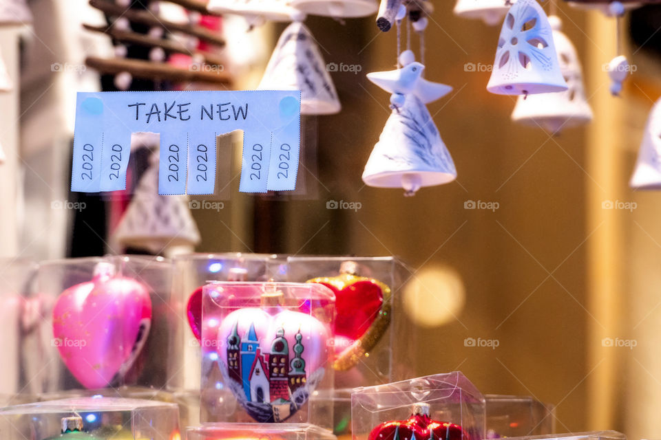 Christmas shop window with paper with the phrase: Take New and with a 2020 sign ready to be tore off
