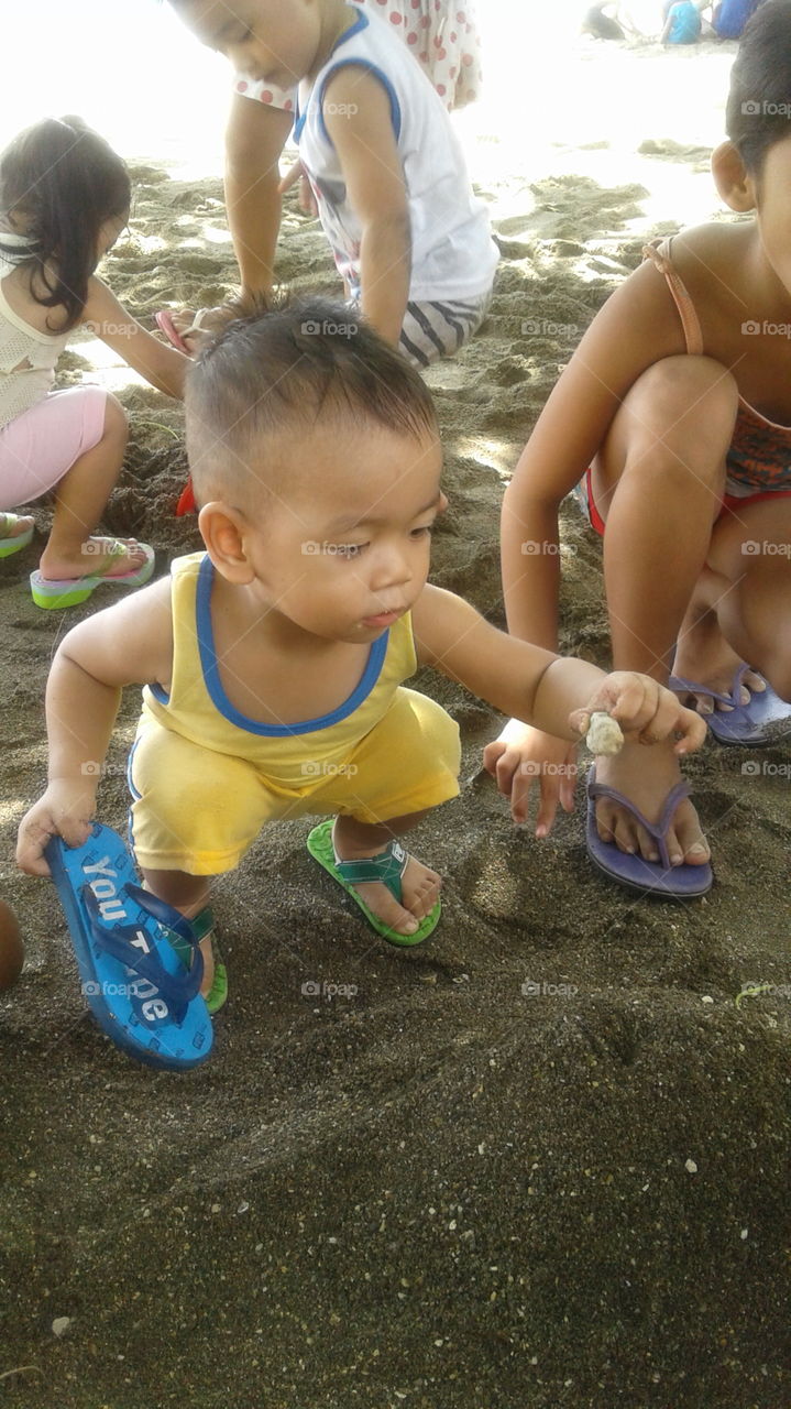 baby playing sand