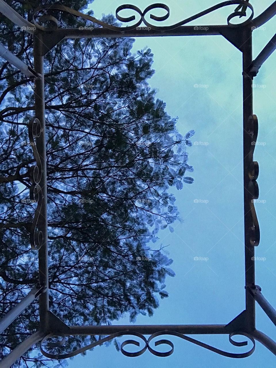 Down to up view of blue sky through the iron swing 