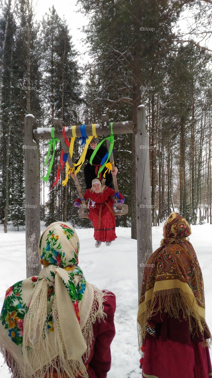 Museum of forest architecture."Malye Karelys"Arkhangelsk.Russia.Easter celebration. seesaw.