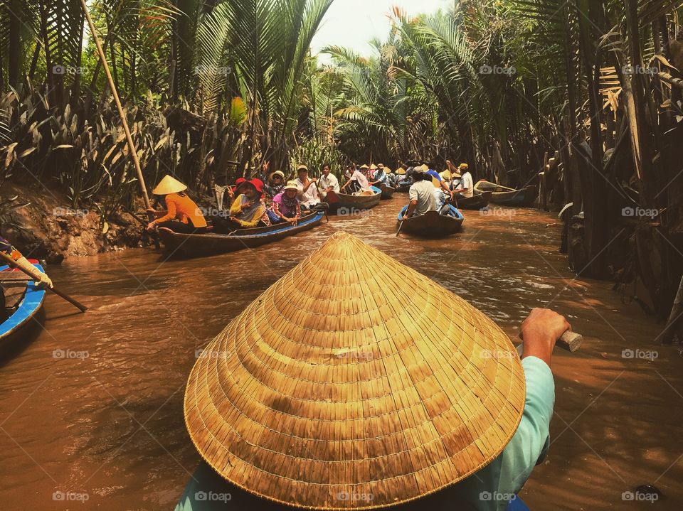 Close-up of person wearing asian style conical hat