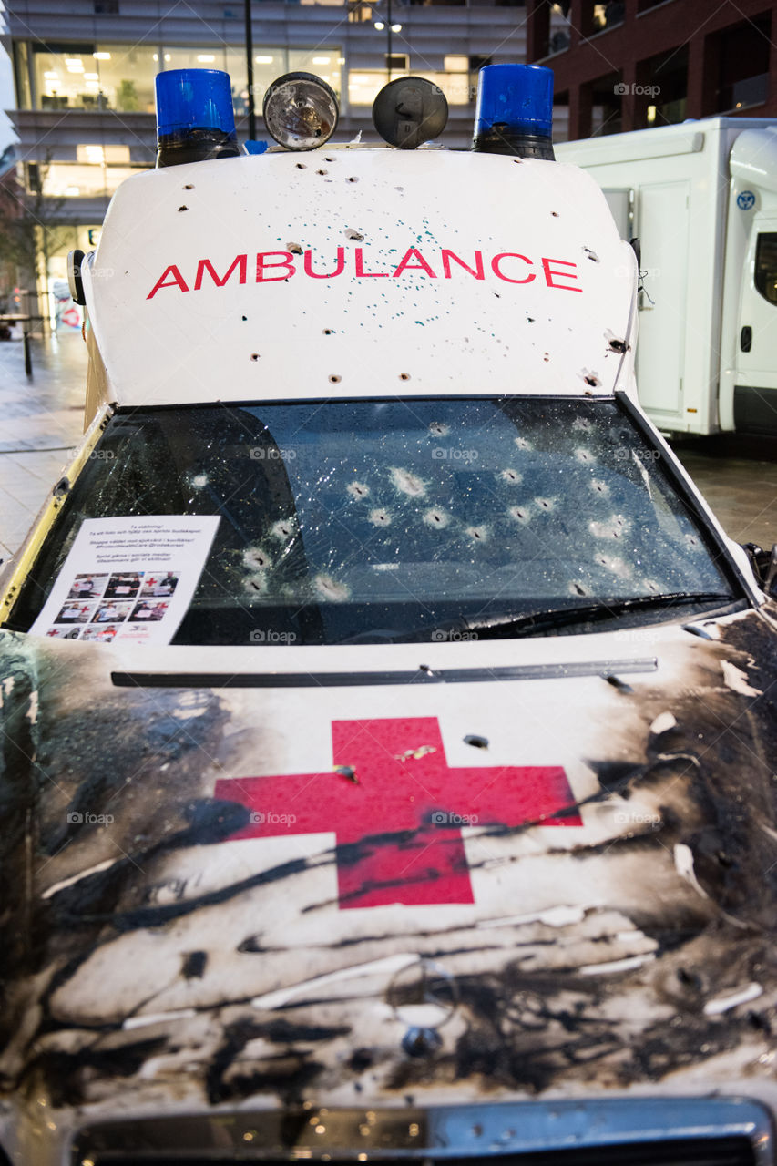 A real ambulance from the Red Cross who had been attacked in war. The Ambulance has bulletholes just everywhere and even firebombs have been thrown against it. The ambulance is part of efforts to make people aware of what happens in war. Ambulance shown up in various parts of the world. The picture is from Malmö Sweden.