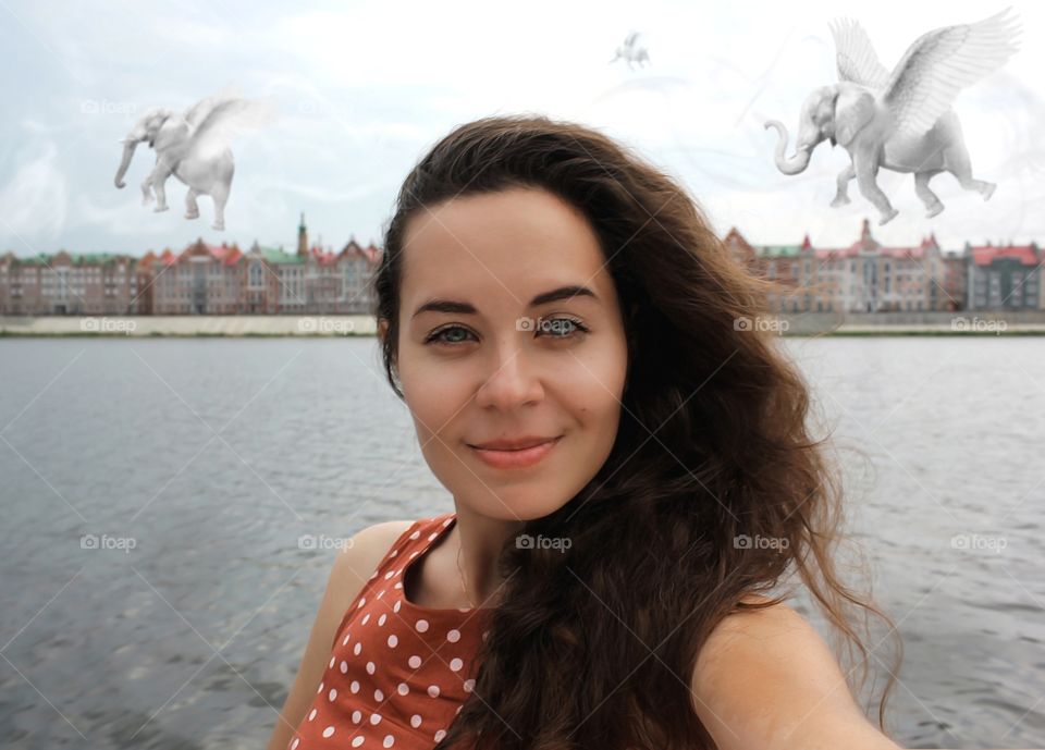 Selfie photo of one brunette with white elephants.