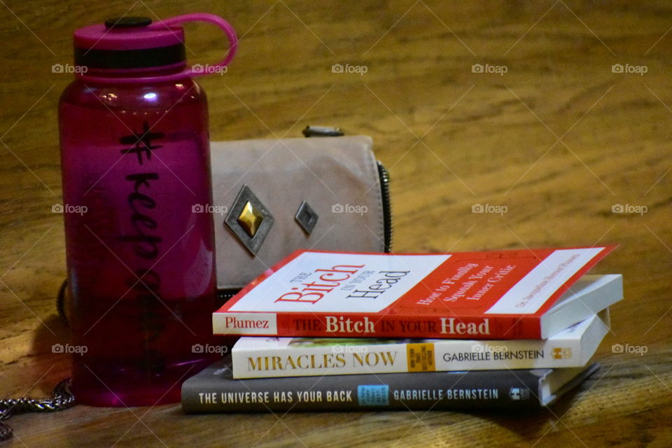 water bottle, purse, and personal development books